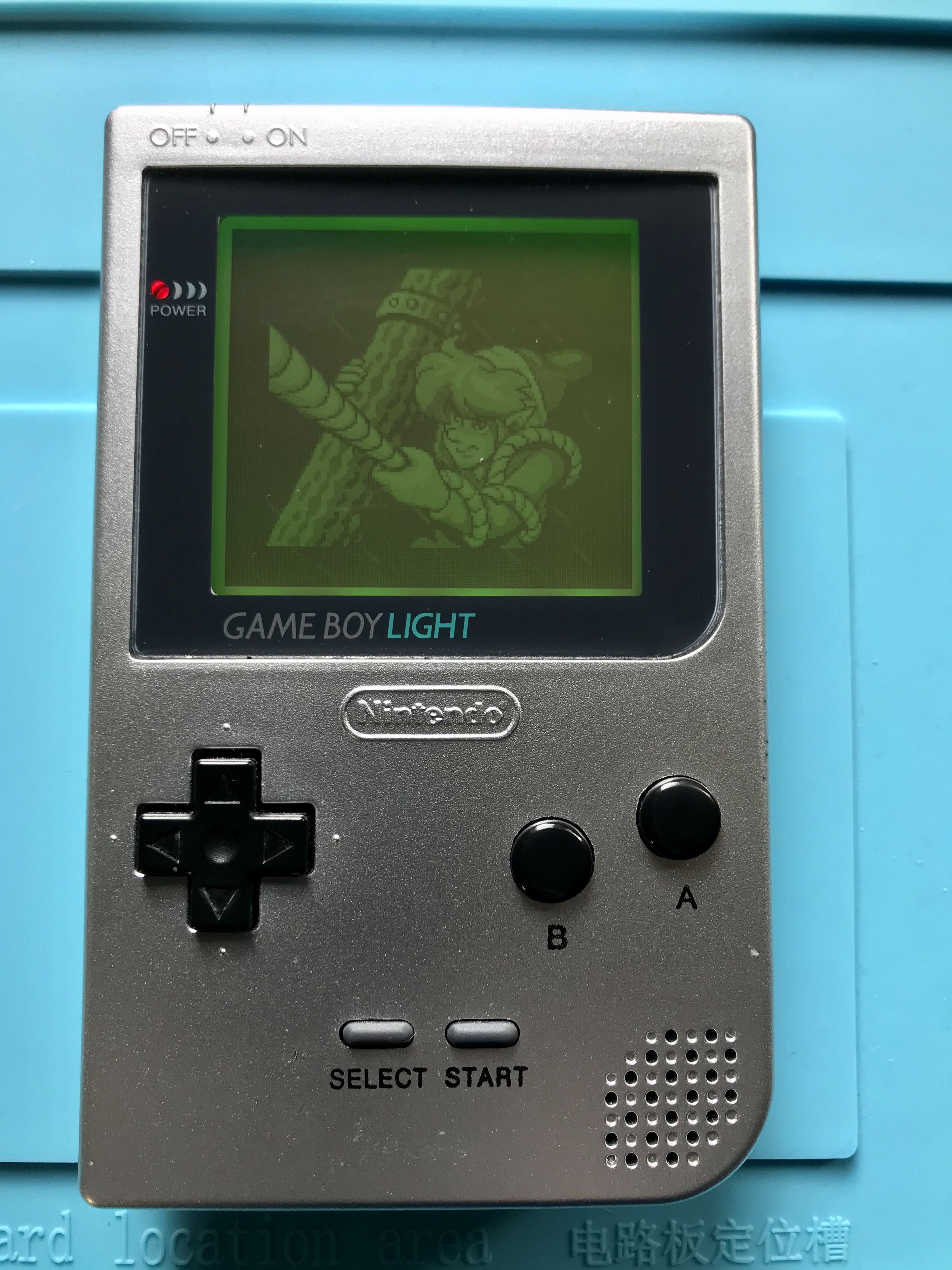 Game Boy Pocket in aftermarket shell with green aftermarket backight