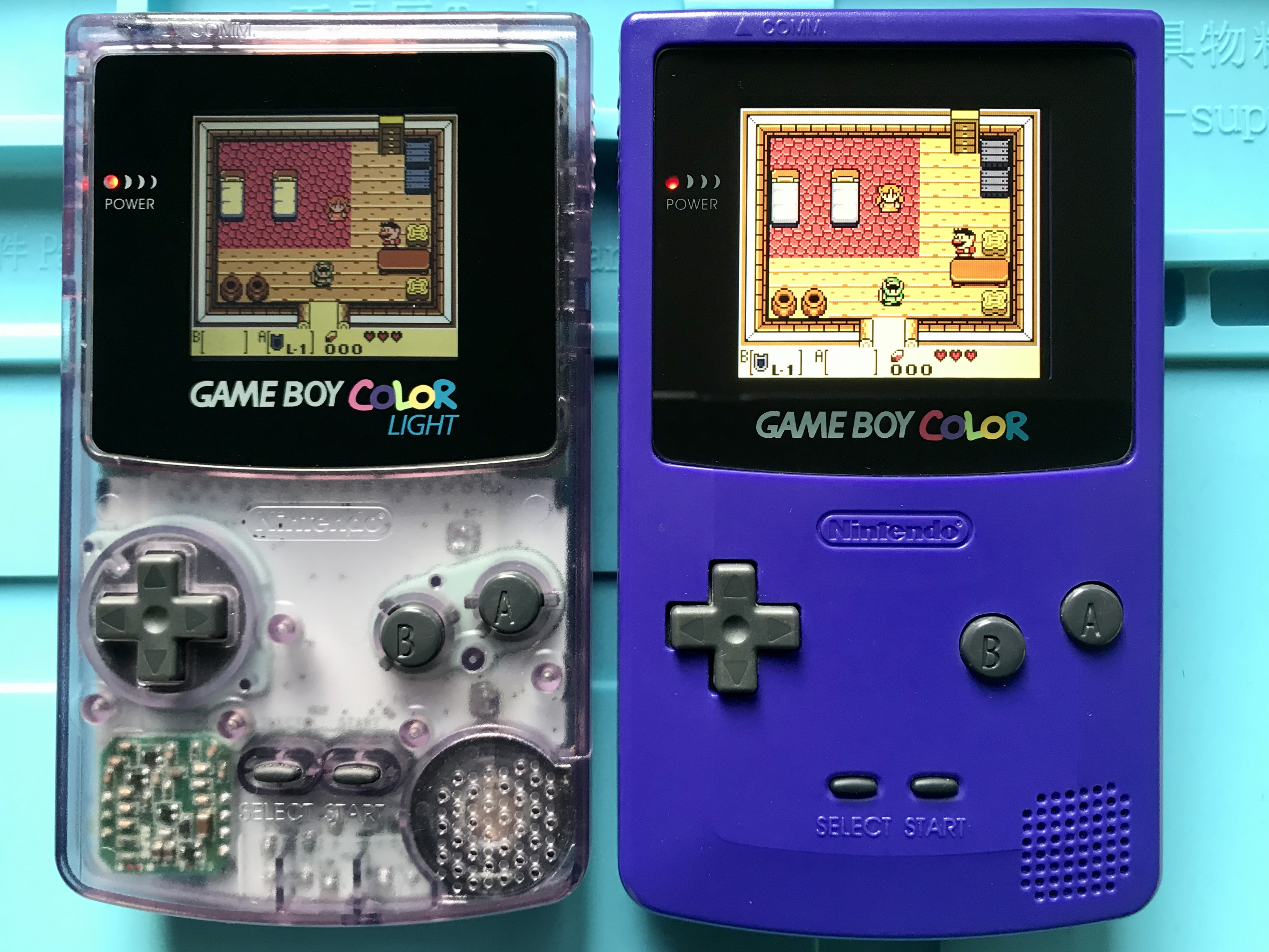 A smaller backlit TFT screen and a full-size IPS Game Boy Color screen mod both set to their maximum brightness.