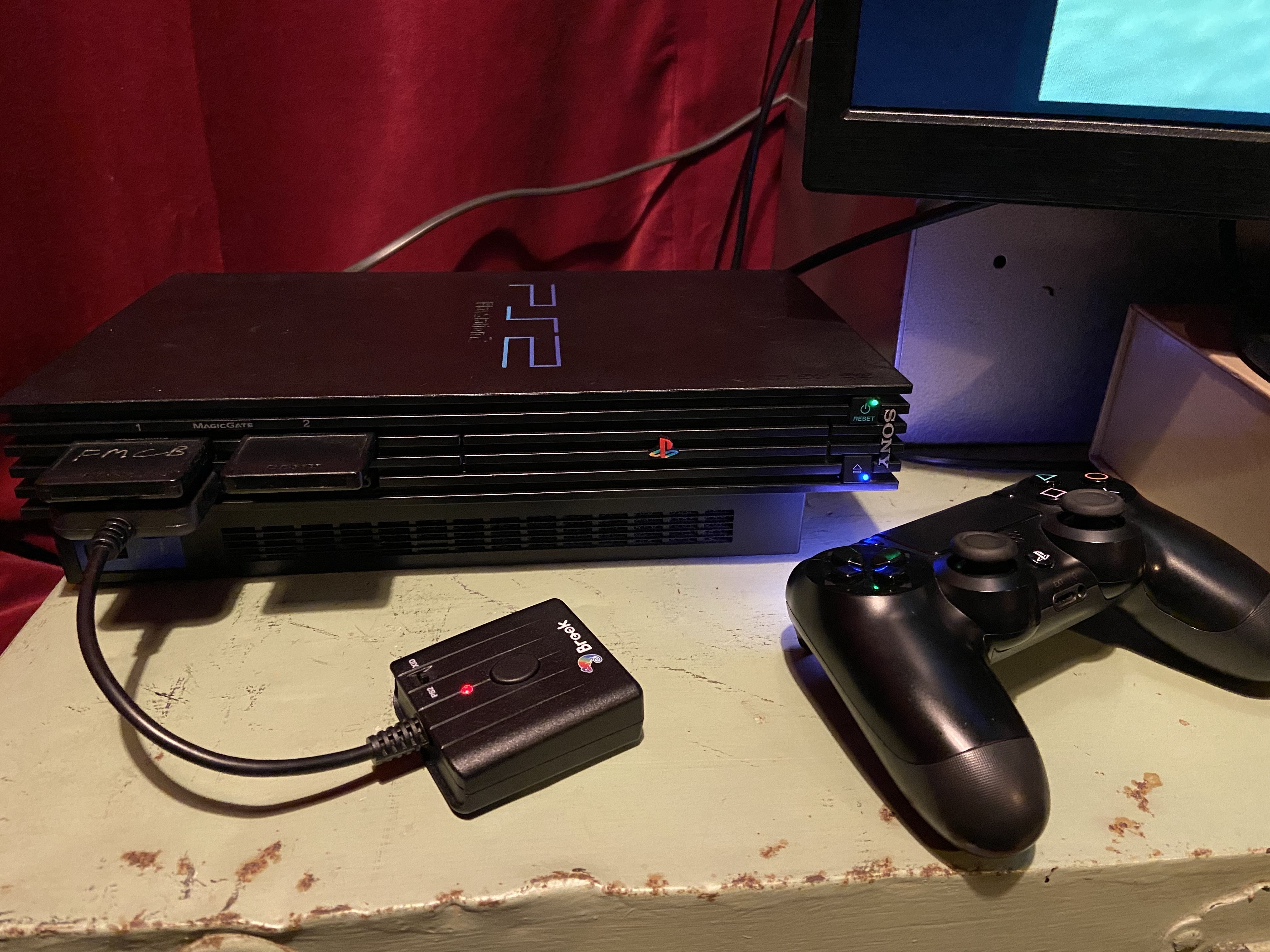 Modded PlayStation 2 using a DualShock 4 via a wireless converter
